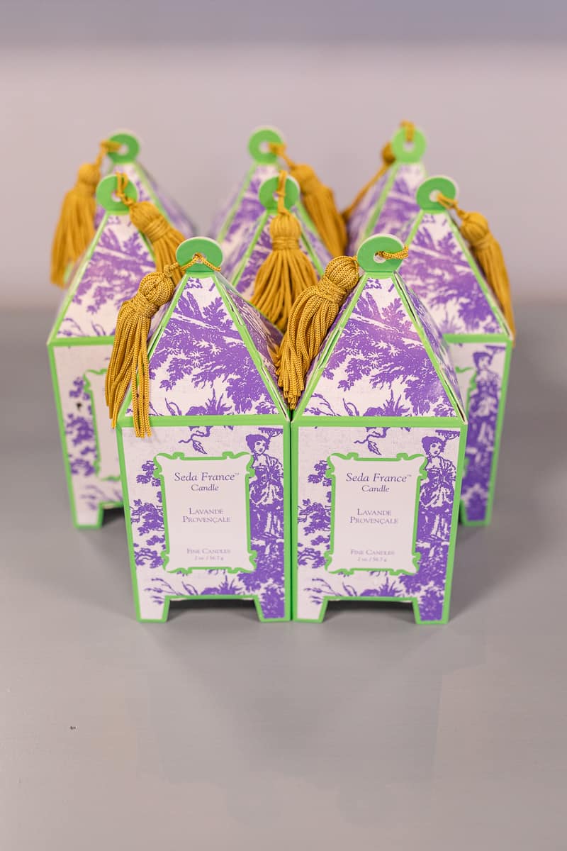 display of scented candles in decorative boxes